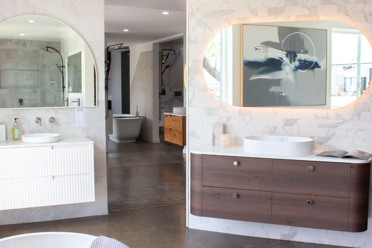 Freestanding bath with black floor-mounted bath mixer