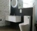 Bathroom Sphere LED mirror in showroom with wall hung vanity and toilet